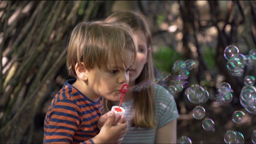 Zwei Kinder mit einem Seifenblasenspiel