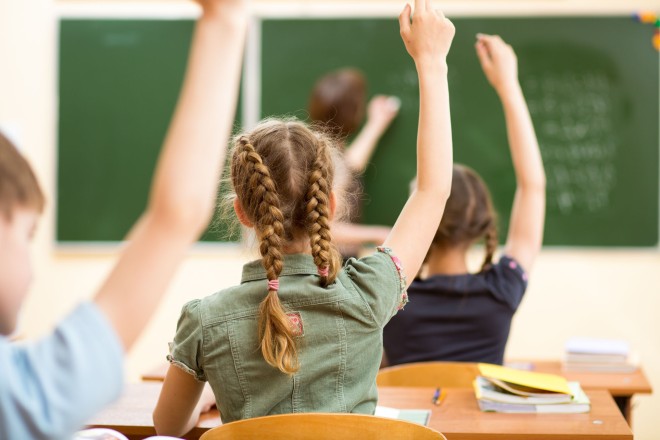 Foto: Schülerinnen und Schüler melden sich im Unterricht